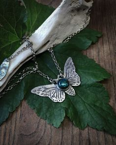 This sterling silver moth pendant necklace was inspired by my visit to Deyrolle's Emporium in Paris. The moth is etched into the surface of the silver by hand using acid etch process and is set with a smooth Labradorite gemstone, that has a bright blue flash and is finished with a loop & bar clasp. Each etched design is unique so may vary slightly. Every Under the Velvet Moon design arrives wrapped ready to be given as a gift. Bohemian Butterfly Sterling Silver Necklace, Bohemian Sterling Silver Butterfly Necklace, Handmade Silver Butterfly Necklace, Unique Handmade Silver Butterfly Necklace, Unique Sterling Silver Butterfly Necklace, Unique Silver Butterfly Pendant Necklace, Moth Pendant, Lunar Moth, The Moth