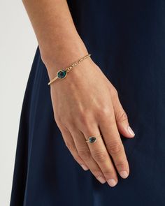 The Twisted Hook Bracelet boasts a distinctively timeless design, handcrafted in 14K solid gold and featuring a pear-shaped London blue topaz stone and a faceted round diamond. The twisted band and petroglyph add a unique touch to this sophisticated bracelet. Whether worn on its own for understated elegance or paired with a pair of Dewdrop Stone Earrings for a coordinated look, this pendant adds a touch of sophistication to any outfit. Metal: 14K solid gold Stone: London blue topaz, diamond Band Elegant Gold Bracelets With Blue Topaz, Teardrop Blue Topaz Jewelry In Yellow Gold, Teardrop Blue Topaz Yellow Gold Jewelry, Yellow Gold Teardrop Blue Topaz Jewelry, Pear-shaped Blue Topaz Yellow Gold Jewelry, Luxury Pear-shaped Blue Topaz Jewelry, Solid Gold Bracelet, Hook Bracelet, Blue Topaz Stone