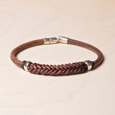 a brown leather bracelet with two metal clasps