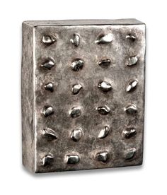 a square metal object with lots of rivets on it