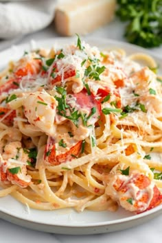 pasta with lobster and parmesan cheese on a white plate