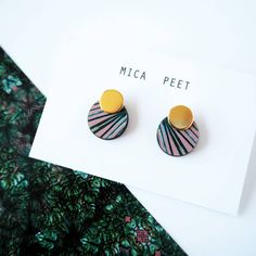 a pair of earrings sitting on top of a card