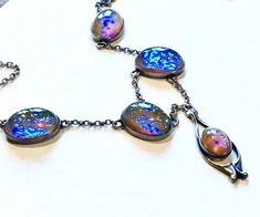 Very beautiful antique festoon necklace! it is Arts&Crafts to Art Nouveau period. Crafted in solid sterling silver. In excellent condition and clasp works well! Very well built! Hallmarked sterling- please see photo. Has 5 big fiery opals paste. Please see photos as part of description. it is 39cm from end to end. first photo shows how it looks next to skin. as with any opal - the best flashes are under bright light; from one side it can be more flashes and from another less. no damages/no c Unique Iridescent Cabochon Necklaces, Elegant Iridescent Cabochon Necklace, Vintage High Luster Silver Jewelry, Vintage Silver Jewelry With High Luster, Silver Fusion Necklace With Cabochon, Silver Oval Necklace With High Luster, Artisan Oval Necklace For Formal Occasions, Artisan Necklace With Cabochon For Formal Events, Riviere Necklace