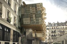 an upside down birdcage on the side of a building in paris, france