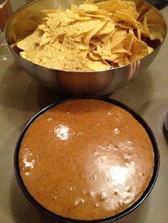 two bowls filled with chips next to a bowl of tortilla chips