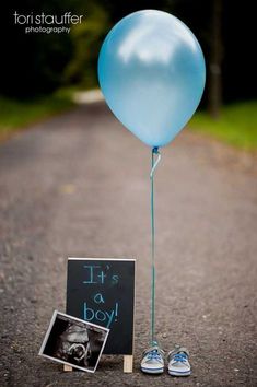 a blue balloon with a chalkboard attached to it next to a pair of tennis shoes