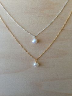 Beautiful. Delicate Lovely 6mm freshwater pearl floats delicately along a 14k Gold Fill chain. Perfect and simple. You can wear it alone for an elegant look or layer it! Also available and photographed with the Silver version, https://www.etsy.com/listing/158536330/pearl-charm-necklace-silver-chain *If you are unsure of the length you need, or would like to wear this item at different lengths, we now offer an adjustable length option! You can add an adjustable end to your necklace using this lin Simple Silver Jewelry With Pearl Charm, Simple Silver Jewelry With Pearl Chain, Simple White Pearl Chain Jewelry, Simple Pearl Drop Necklace For Gifts, Simple White Pearl Necklace For Everyday, Simple White Pearl Drop Necklace, Simple Pearl White Jewelry With Pearl Charm, Simple Silver Pearl Jewelry, Simple White Pearl Necklace As Gift