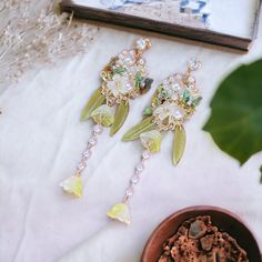 ⭐️ Introducing our stunning botanical-style earrings, featuring intricate designs of delicate Lily of the Valley flowers. Each flower petal is meticulously crafted to showcase the intricate details of this beautiful flower. ⭐️ Handcrafted with exceptional attention to detail, these earrings are a true work of art. The green color of the design adds a touch of spring to any outfit, while the simple dangles allow the botanical design to be the star of the show. ⭐️ These earrings are versatile and easy to style, making them a perfect addition to any jewelry collection. Whether you're dressing up a casual outfit or adding the finishing touch to a formal dress, these earrings will add a touch of elegance to any ensemble. 🎁 Our botanical-style earrings also make a great gift for any occasion. T Elegant Beaded Flower Earrings For Spring, Elegant Spring Jewelry With Birth Flower Details, Elegant Spring Beaded Earrings, Spring Gift Chandelier Drop Earrings, Spring Gift Drop Chandelier Earrings, Spring Gift Chandelier Dangle Earrings, Elegant Spring Chandelier Earrings, Spring Wedding Dangle Flower Earrings, Elegant Spring Birth Flower Jewelry