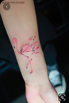 a small pink flamingo tattoo on the left inner arm and wrist, by hot tattoo studio