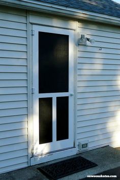 a white house with a black screen door