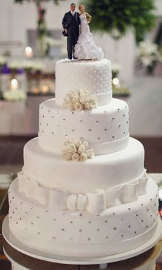 a wedding cake with a bride and groom figurine on top