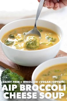 broccoli cheese soup in a white bowl with a spoon