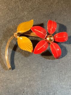 Vintage gold tone enamel flower brooch. Red and yellow enamel flower 2 x 1.25 inches Brooch enamel has home wear on the edges and near the center. Single rivet on the flower back and not signed. Firm lock pin clasp.   (D569) Red Enamel Brooch, Red Enamel Brooch Pin, Yellow Enamel Brooches For Gifts, Retro Flower Brooches For Collectors, Floral Enamel Brooch Pin, Flower Shaped Enamel Brooch Pin, Flower Shaped Enamel Brooch, Vintage Red Enamel Brooches, Red Enamel Vintage Brooch