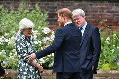 two men and a woman are shaking hands