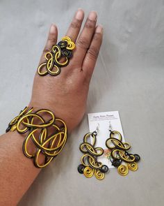 "Black and gold colored jewelry set, this beautiful cuff bracelet, ring, and matching earrings are a statement set that will get plenty of compliments. Made of non-tarnish, lightweight aluminum wire. The cuff is adjustable and the earrings are 3\" long with surgical steel ear wires. Be sure to choose your ring size. I want my customers to be happy, so please look carefully at the photos, and feel free to ask any questions. I post new items as soon as they are created so please come back and visi Handmade Yellow Bangle Jewelry, Unique Yellow Metal Jewelry, Adjustable Gold Jewelry Sets With Matching Earrings, Unique Yellow Jewelry With Matching Earrings, Elegant Yellow Jewelry With Unique Variations, Elegant Adjustable Yellow Cuff Bracelet, Elegant Yellow Metal Jewelry, Adjustable Yellow Jewelry Sets For Gift, Elegant Yellow Cuff Bracelet As Gift