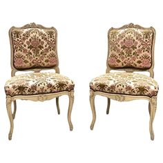 two antique style chairs with floral upholstered cushions