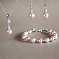 A contemporary 3-piece jewellery set featuring quality Swarovski pearls in lovely light pink blush colour (Rosaline) and bright silver plated stardust beads. Perfect for any occasion, weddings and parties or as a gift. Set contains pendant style necklace with a delicate silver plated chain, beaded bracelet and a pair of drop earrings. Organza gift bag included!  Please note that although I take a great care to keep the colours on the photographs as close to reality as possible, they may look sli Affordable Pink Jewelry With Silver Beads, Cheap Pink Jewelry With Silver Beads, Pink Sterling Silver Jewelry With Round Beads, Sparkling Silver Pearl Jewelry, Silver Pearl Jewelry Sets With Round Beads, Elegant Pink Sterling Silver Jewelry Sets, Pink Pearl Drop Jewelry With Round Beads, Pink Round Beads Jewelry For Bridesmaid Gift, Pink Pearl Jewelry Sets For Gifts