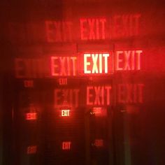 an exit sign is lit up in red