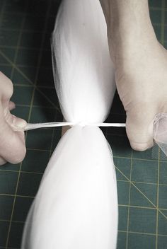 a person with their foot on a piece of paper being taped to the ground by a pair of scissors