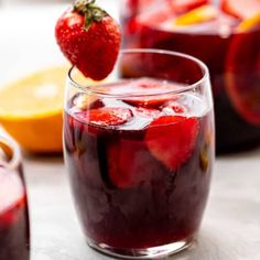 two glasses filled with liquid and strawberries