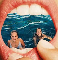 two women are in the water with their mouths open and one woman is swimming behind them