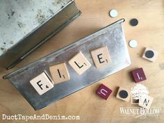 scrabble tiles spelling the word file on top of a wooden table with letters