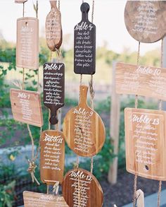 a wooden sign hanging from the side of a building