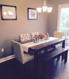 a dining room table with chairs and a bench