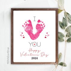 a valentine's day card with the words i love you and two pink handprints