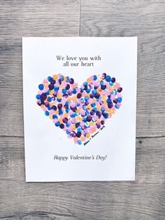 a valentine's day card with confetti in the shape of a heart