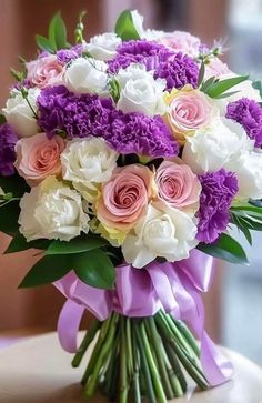 a bouquet of purple and white flowers on a table