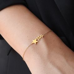 Discover our Dainty 3 Stars Solid 18K Gold Bracelet--an understated yet elegant piece crafted to elevate your style. With its minimalistic design and sleek gold finish, this bracelet exudes sophistication and charm. Adorn your wrist with this timeless accessory and make a statement of refined taste and understated luxury. Gold specifications: *Caliber: Solid 18K gold- The optimal caliber for creating high-end Jewelry pieces. At 75% purity, the metal proprieties are fully released, and Gold achie Yellow Gold Minimalist Bracelet For Parties, Minimalist Yellow Gold Bracelet For Party, Party Minimalist Yellow Gold Bracelet, Minimalist 14k Gold Bracelets For Party, Gold Minimalist Diamond Bracelet For Party, Minimalist Yellow Gold Party Bracelet, Dainty Yellow Gold Bracelet For Party, Elegant Yellow Gold Star Jewelry, Elegant Everyday Bracelets With Star Charm