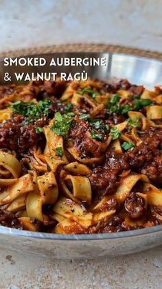 a bowl filled with pasta and meat sauce