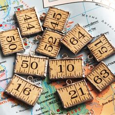 wooden rulers are on top of a map with the word measure spelled in black and white