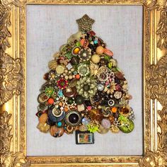 there is a gold frame with a christmas tree made out of buttons and other items