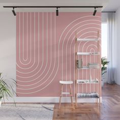 a pink wall with white lines on it and a chair in front of the wall