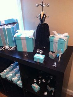 a black table topped with blue boxes and jewelry