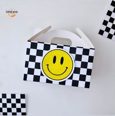 a box with a smiley face on it and some black and white checkered paper