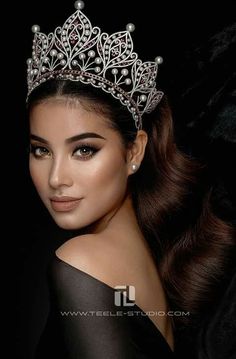 a beautiful woman wearing a tiara with pearls on it's head and long hair