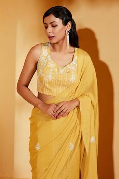 Yellow georgette crepe saree with sequins embroidered motifs. Comes with a padded blouse.
Components: 2
Pattern: Embroidered
Type Of Work: Sequins motifs
Neckline: V Neck
Sleeve Type: Sleeveless
Fabric: Georgette crepe
Color: Yellow
Other Details: 
Product Weight: Approx 4-5 Kgs
Model Height: 5ft 7inches, wearing size S
Closure: Blouse - Back hooks
Occasion: Mehendi and Haldi - Aza Fashions Embroidered Motifs, Crepe Saree, Padded Blouse, Blouse For Women, Saree With Blouse, Blouse Online, Embroidered Blouse, Aza Fashion, Model Height