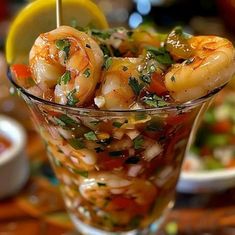 a glass bowl filled with shrimp and vegetables