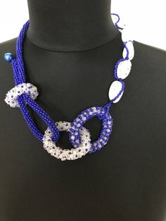 I've used different techniques of beading to create this blue and white bead necklace that is a unique piece of art every woman will be proud to wear for any special occasion, especially around the holidays. It's made of blue and white seed beads and has an unusual artistic and interesting design. Unique White Beaded Jewelry, Elegant Handmade Blue Necklaces, Unique Blue Necklaces With Spacer Beads, Unique Blue Beaded Necklaces, Unique Blue Beaded Chain Necklace, Handmade White Beads Long Necklace, Handmade Long White Beads Necklace, White Beaded Long Crystal Necklace, Unique Blue Beaded Necklace