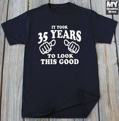 a black t - shirt that says it took 25 years to look this good with two fists