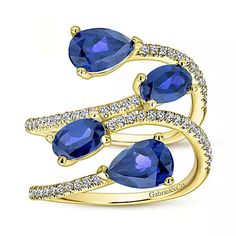 Indulge in luxury with Gabriel & Co.'s Blue Sapphire & Diamond Right Hand Geometric Ring. This sophisticated ring features two open bands, adorned with shimmering 0.36ct pavé diamonds and pairs of oval and pear shaped sapphires. The perfect combination of elegance and unique design for the modern woman. Available in 14K or 18K white, rose or yellow gold Includes ring box Includes jewelry appraisal Ships fully insured to point of delivery All rings are fully customizable by Gabriel should you prefer slight or major changes to the style you see. Alteration possibilities include alternate color gemstones, styling or metal preference. Diamond Right Hand Ring, Gabriel Jewelry, Right Hand Ring, Jewelry Appraisal, Right Hand Rings, Blue Sapphire Diamond, Hand Ring, Geometric Ring, Sapphire Diamond