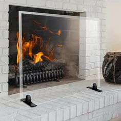 a fireplace that has some kind of fire burning in it's mantle and is white brick