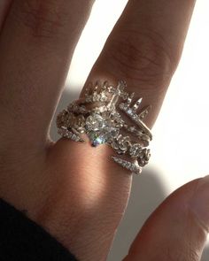 a woman's hand with a diamond ring on it