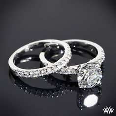 two white gold wedding rings with diamonds on black background, close - up view photo