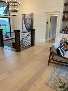 a living room filled with furniture and a large painting hanging on the wall above it