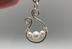 Natural white pearls and sterling silver. Genuine pearls "floating" in hand-wrought sterling silver. Earrings each have one 6mm pearl and measure approximately 18mm x 12mm. Pendant has one 6mm pearl and two 4mm pearls and measures approximately 24mm x 15mm. These are handmade, so please expect some slight variation. Please note that the pendant does not come with a chain. Purchase as a set or as one pair of earrings and/or one pendant.  Pearls are the birthstone for June, and they're just classy. I personally select the beads and materials from the very best in my stock to ensure that you are happy with your product. Please let me know if for any reason you are not.  View my other listings at https://www.etsy.com/shop/cultivatedelements/. Sterling Silver Pearl Pendant Earrings, Unique Sterling Silver Pearl Earrings As Gift, Hand Forged Dangle Pearl Earrings For Gifts, Silver Wire Wrapped Pearl Earrings Gift, Hand Forged White Jewelry For Gifts, Earring Ideas, Pearl Earring, Wedding Jewelry Earrings, Wedding Earrings