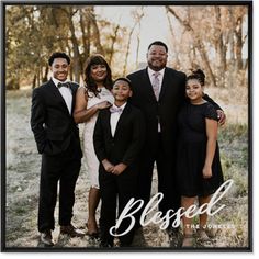 a family posing for a photo with the word blessed in front of them and trees behind them